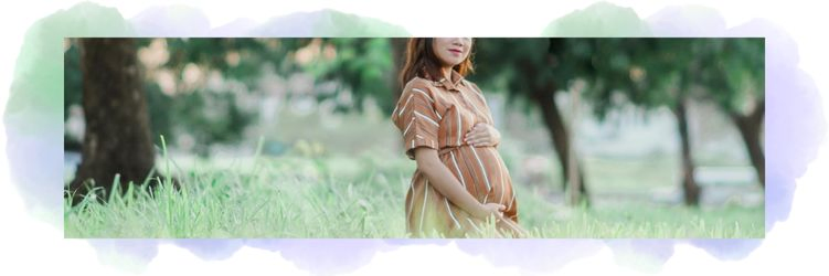 Image correspondant à la section d'articles sur la grossesse. On aperçoit une femme enceinte qui pose ses mains sur son gros ventre dans une prairie.