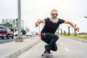 Un senior sur un skateboard car il a pris de la PQQ pour avoir plus d'énergie.