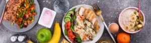 Menu sans gluten : des plats à base de viande, légumes et fruits sur un plan de travail.