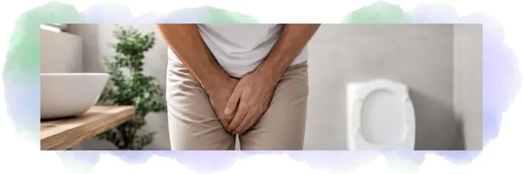 Un homme se tient les mains au niveau de la vessie en signe de trouble urogénital.
